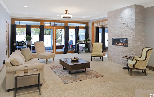 living room featuring french doors, a stone fireplace, a wealth of natural light, and ornamental molding