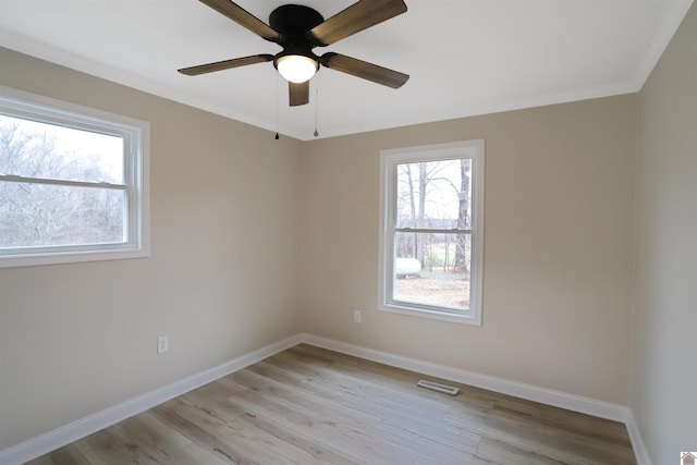 spare room with ceiling fan and light wood-type flooring