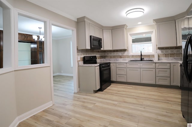 kitchen with electric range, gray cabinets, and sink