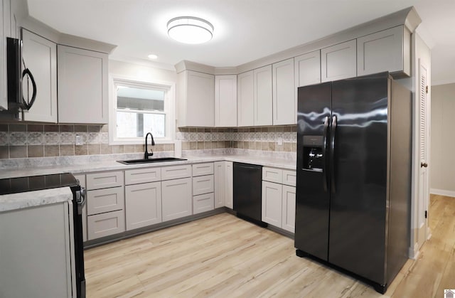 kitchen with refrigerator with ice dispenser, black dishwasher, gray cabinets, and sink