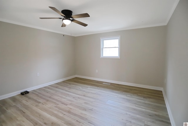 spare room with ceiling fan, crown molding, and light hardwood / wood-style floors