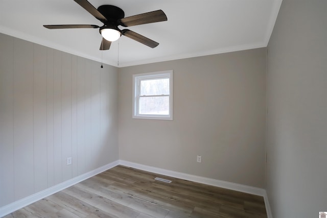 unfurnished room with ceiling fan, crown molding, and wood-type flooring