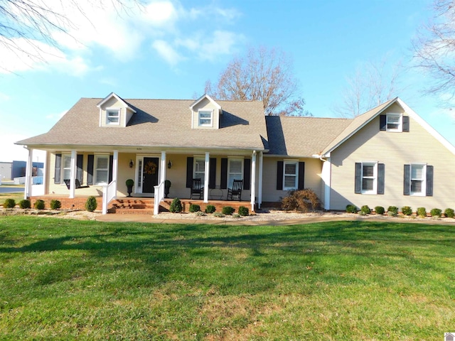 cape cod house featuring a porch and a front yard