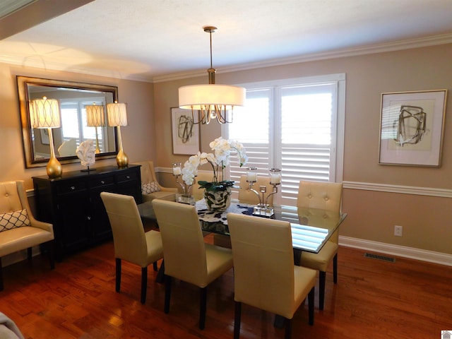 dining area with dark wood-type flooring, plenty of natural light, and ornamental molding