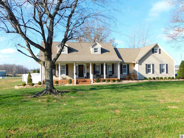 cape cod-style house with covered porch and a front yard