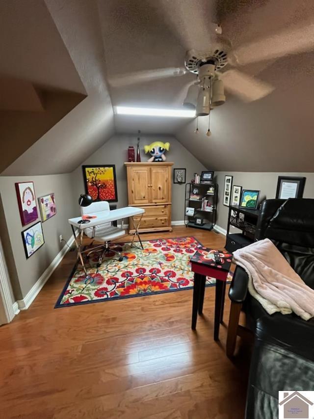 rec room featuring ceiling fan, wood-type flooring, and lofted ceiling