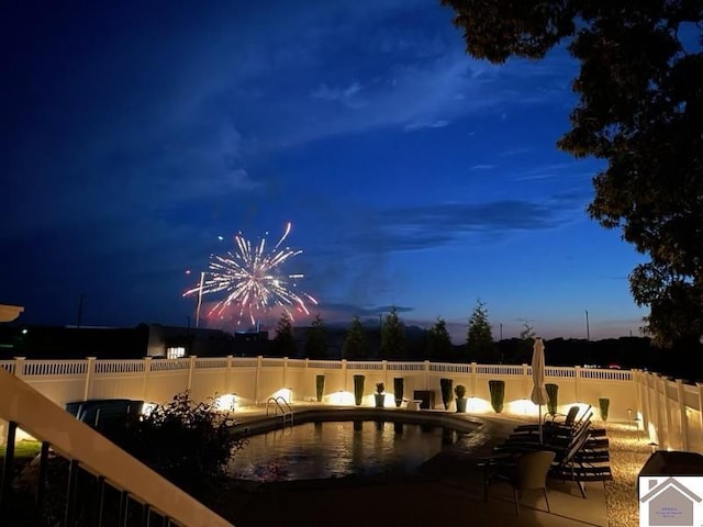 view of pool at dusk