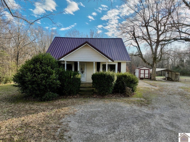 view of front of property featuring a porch, a shed, and a carport