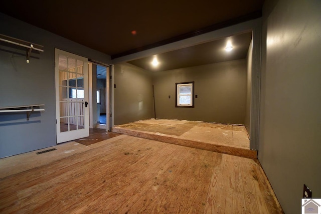 unfurnished room with hardwood / wood-style flooring