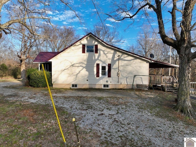 rear view of house featuring a deck