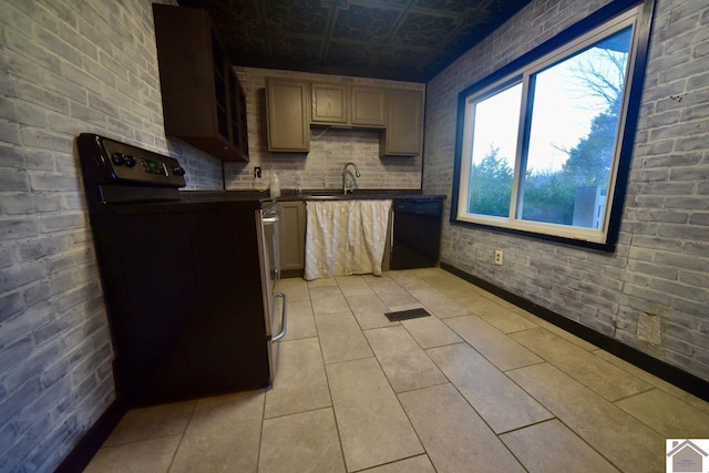 kitchen with sink, light tile patterned floors, black appliances, and brick wall