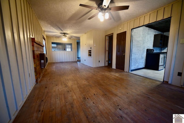 unfurnished living room featuring ceiling fan, light hardwood / wood-style floors, and a textured ceiling