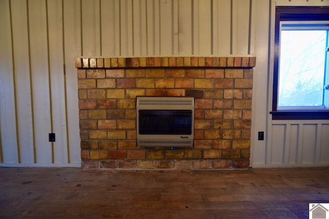 room details featuring heating unit and hardwood / wood-style flooring