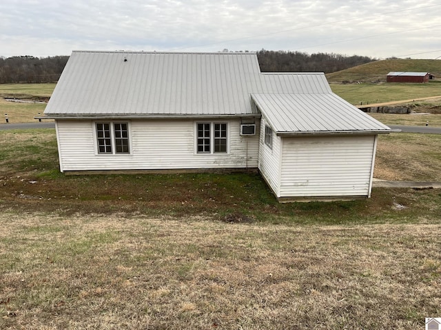 back of house with a lawn