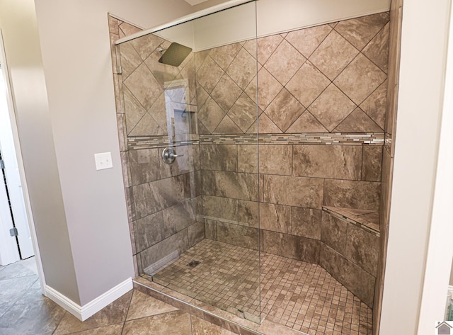 bathroom featuring tile patterned floors and a tile shower