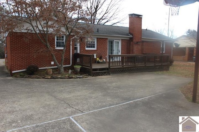 rear view of property featuring a wooden deck