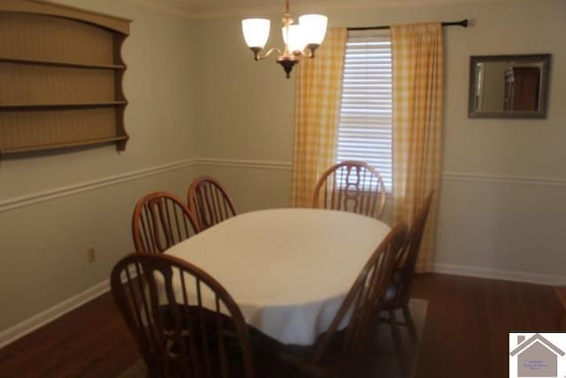 dining area featuring a notable chandelier, crown molding, and dark wood-type flooring