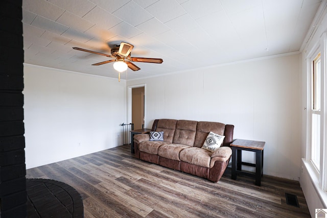 living room with ceiling fan, dark wood-type flooring, and ornamental molding