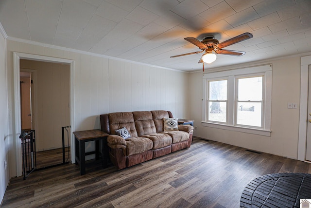 living room featuring ceiling fan, crown molding, and dark hardwood / wood-style floors