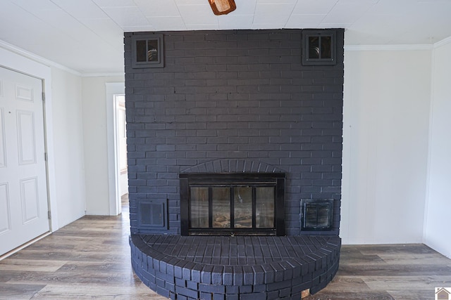 details featuring a fireplace, wood-type flooring, and crown molding