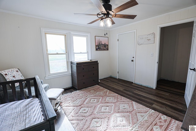 bedroom featuring a closet, ceiling fan, dark hardwood / wood-style flooring, and crown molding