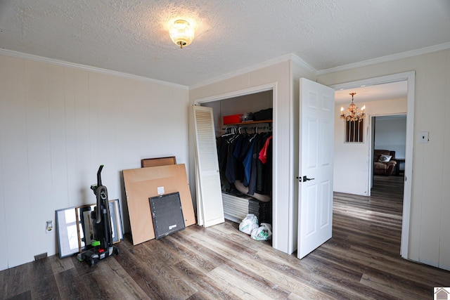 bedroom featuring dark hardwood / wood-style flooring, a textured ceiling, a closet, and ornamental molding