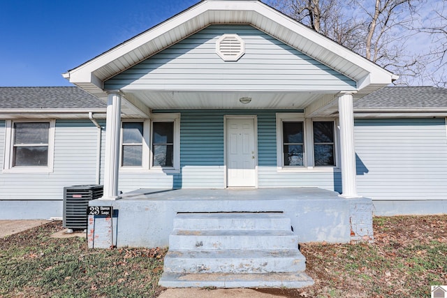 view of front of house with a porch and central AC