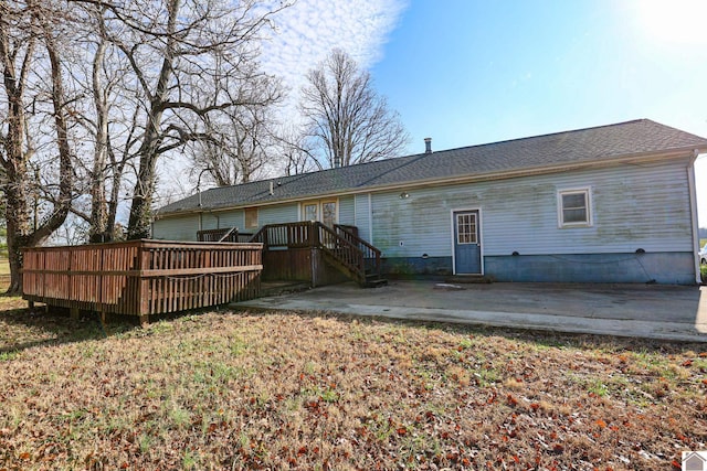 rear view of property featuring a patio area and a wooden deck