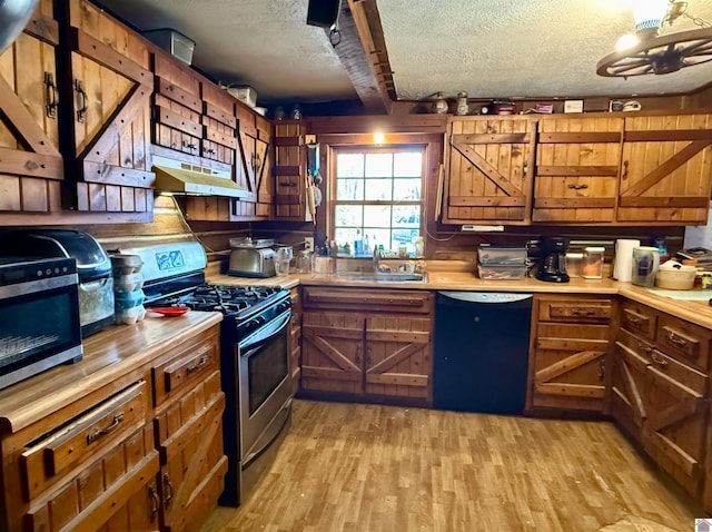 kitchen with sink, stainless steel gas stove, black dishwasher, beamed ceiling, and a textured ceiling