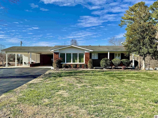 ranch-style home with a front lawn and a carport