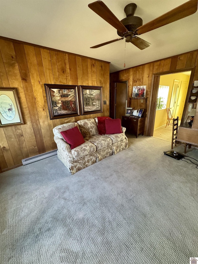 living room featuring baseboard heating, light carpet, ceiling fan, and wood walls