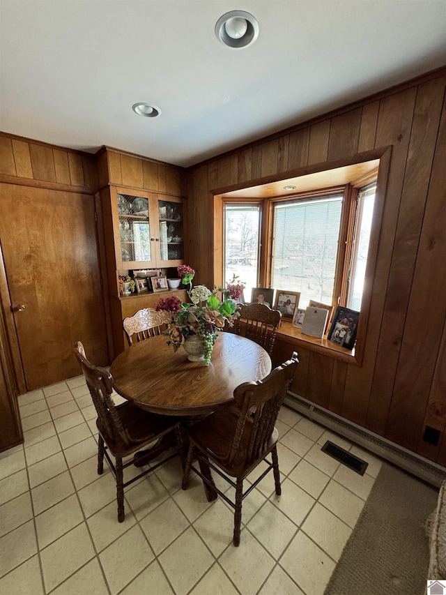 tiled dining space with wooden walls