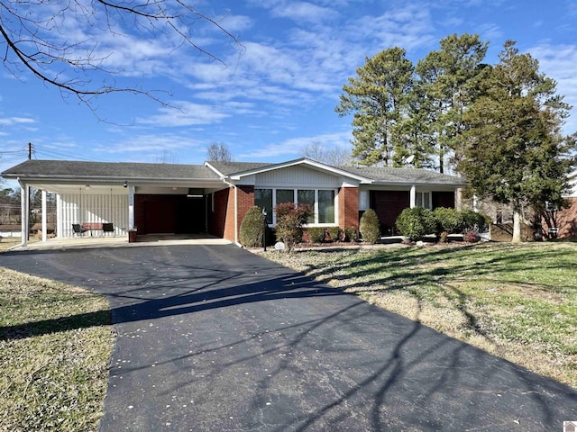 single story home with a carport and a front lawn