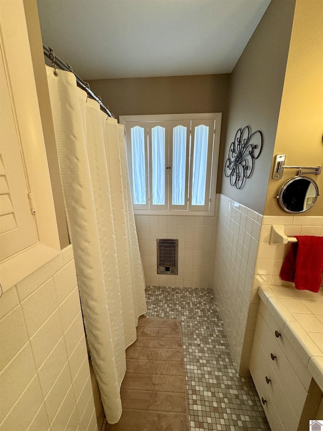 bathroom featuring tile patterned floors, tile walls, and heating unit