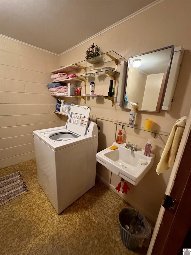 laundry room with ornamental molding, sink, and washer / clothes dryer