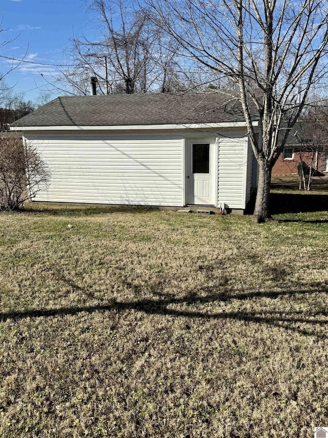 view of outbuilding featuring a yard