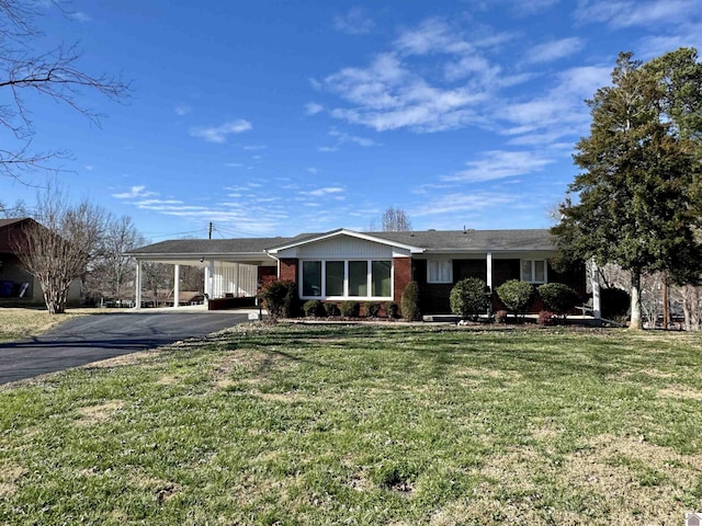 ranch-style home with a front yard and a carport