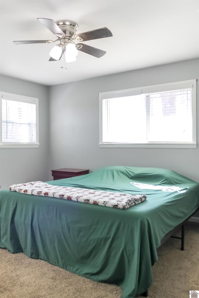 carpeted bedroom featuring ceiling fan