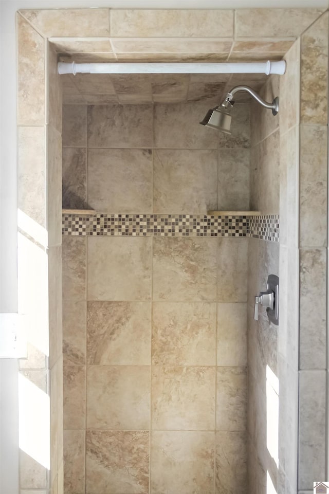 bathroom with tiled shower