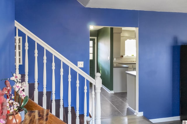 stairway with tile patterned flooring