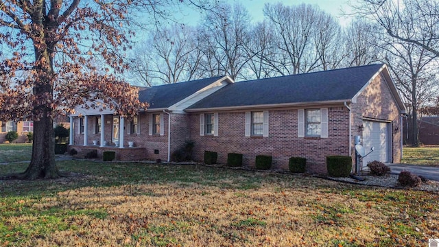 view of front of home with a front yard and a garage