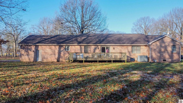 back of house with a wooden deck and a lawn