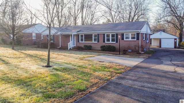 view of front of property featuring a garage, an outbuilding, and a front lawn