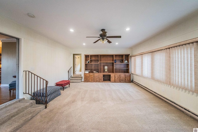 sitting room with baseboard heating, ceiling fan, and carpet floors