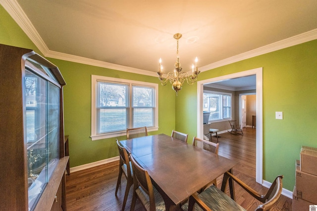 dining area featuring a chandelier, dark wood-type flooring, and ornamental molding