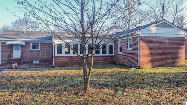 view of side of home featuring a yard