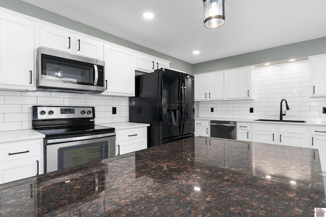 kitchen featuring tasteful backsplash, sink, white cabinets, and stainless steel appliances