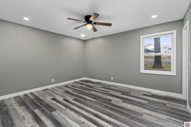 empty room featuring ceiling fan and dark wood-type flooring