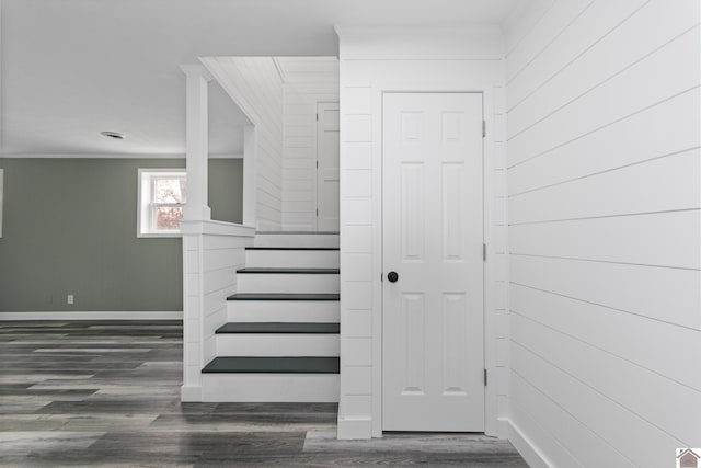 stairs with hardwood / wood-style floors and crown molding