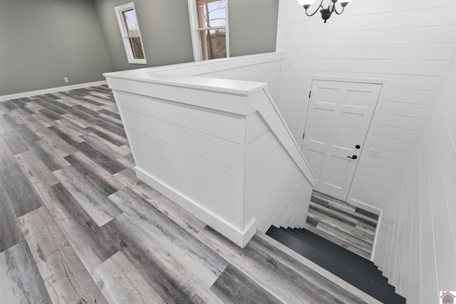 interior details with wood-type flooring and an inviting chandelier